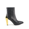 Botín de cuero negro y tacon alto color dorado para mujer.